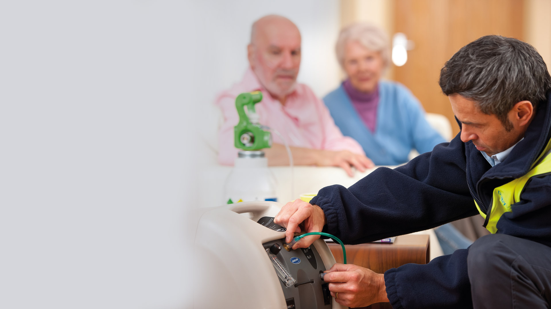 Dolby Vivisol technician installing oxygen device to elderly couple in their home